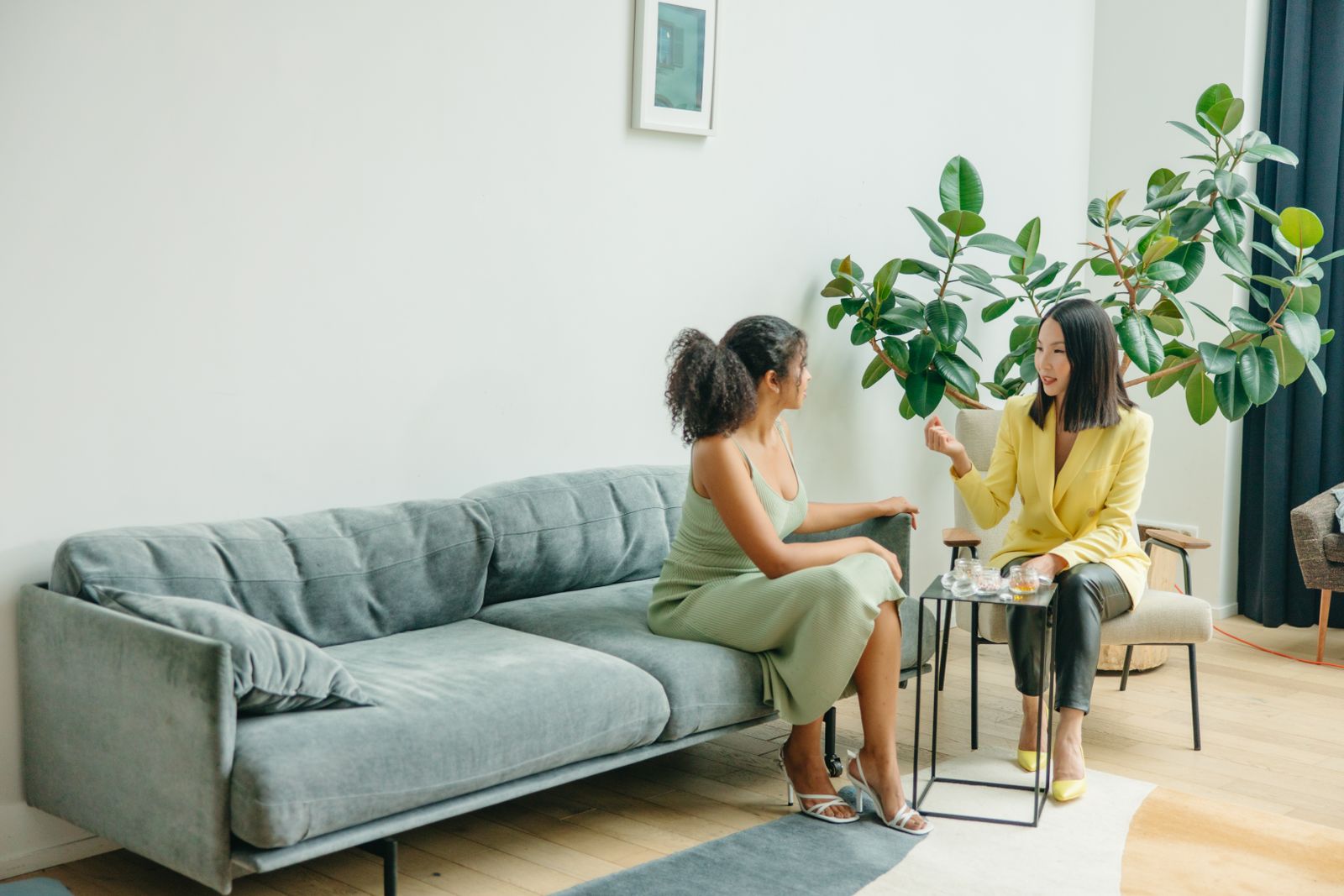 A coach in conversation with a client in a bright room